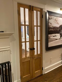 a living room with wood floors and white walls