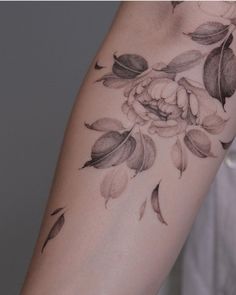 a woman's arm with flowers on it