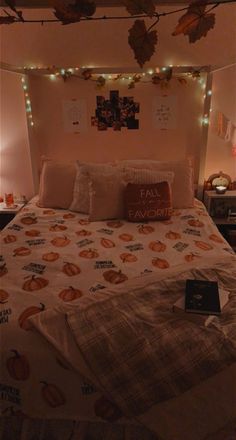 a bed with pumpkins and lights on the headboard