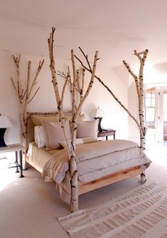 a bedroom with white walls and beige bedding