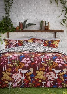 an image of a bedroom setting with flowers on the comforter and bed linens