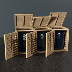 three wooden bins with their lids open on a black table and one has two blue trash cans in it