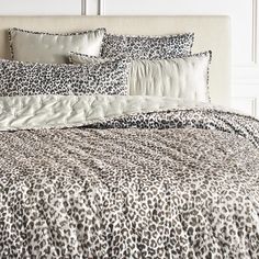 a leopard print comforter set on a bed