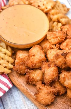 some fried food is on a wooden board