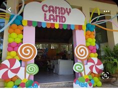 a candy land entrance decorated with balloons and streamers