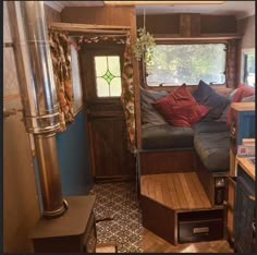 the interior of an rv with wood flooring and blue walls, including a couch