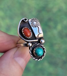 Native American Red Coral and Turquoise Sterling Ring - Size 5 This vintage Native American ring features a round turquoise and an oval red coral. Design elements of a stamped flower on a sterling tab, twisted wire, and sterling balls.  Looks good whichever direction you would like to wear itcoral on the top, or on the bottom. Split shank band.  Fit: Sits at size 5 on the ring mandrel, and fits as a size 5. Face of ring is 1 1/8" long 4.22 grams Marked: Sterling, W  Every jewelry order ships out cleaned, polished, gift boxed, and securely packaged for shipping.  Photos taken outside in natural light. Kindly disregard any weird reflections on the silver, (such as green tinting from the trees).  In very good vintage condition, but might have wear consistent with a well-loved piece. pv2412 Southwestern Multi-stone Oval Turquoise Ring, Southwestern Oval Turquoise Multi-stone Ring, Southwestern Sterling Silver Red Ring, Southwestern Red Sterling Silver Ring, Southwestern Style Red Turquoise Ring, Southwestern Multi-stone Red Ring, Southwestern Red Multi-stone Ring, Red Southwestern Multi-stone Rings, Adjustable Southwestern Red Rings