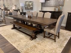 a large dining room table and chairs in a showroom with wood flooring on the other side