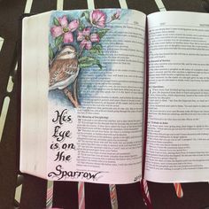 an open book with a bird and flowers on the page, which reads miss love is on the sparrow