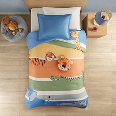 a child's bed with a colorful tiger and giraffe comforter set