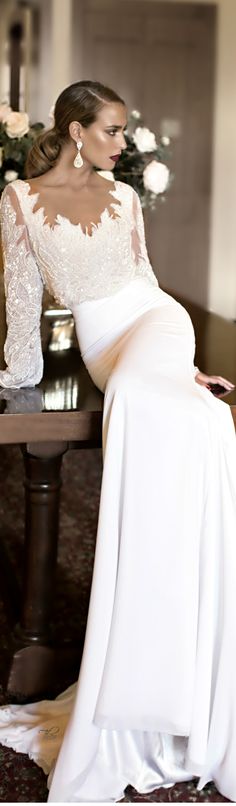 a woman in a white dress sitting on a table