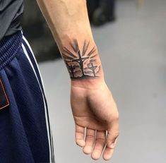 a person with a cross tattoo on their arm