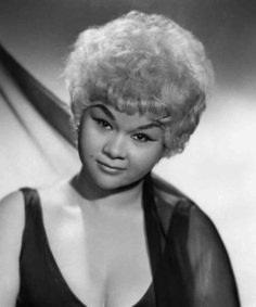 an old black and white photo of a woman with blonde hair wearing a short wig