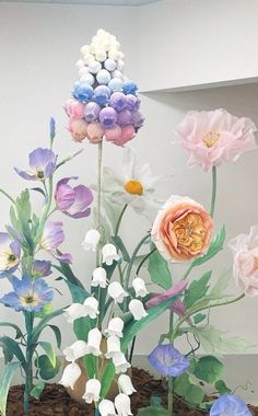 an arrangement of flowers is displayed in a vase