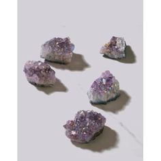 five pieces of purple and white rock sitting on top of a table