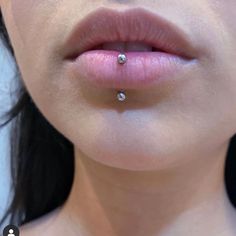 a woman's nose with a piercing on top of her lip and the bottom part of her mouth