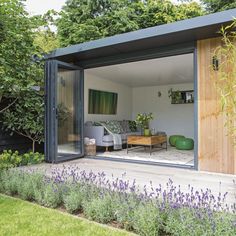 an outdoor living area with plants and flowers