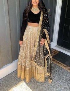 Elevate your style quotient with our exquisite Gold Net Lehenga Blouse. This handcrafted ensemble is designed to make you stand out at special occasions, be it a wedding, festive celebration, or any glamorous event. Key Features: Material: Lehenga Crafted from high-quality Embroidered net. Blouse is made of velvet fabric. Dupatta is in net. Design: The blouse features a timeless design with a sweetheart neckline. Color: Gold Lehenga and black blouse. Care Instructions: To ensure the longevity of this beautiful piece, we recommend dry cleaning only. Net Lehenga Blouse, Black Velvet Blouse Design, Gold Lengha, Velvet Blouse Design, Lehenga Choli Designer, Black Blouse Designs, Lehenga Choli Designs