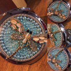 some blue pearls and gold jewelry on a wooden table next to a mirror with two mirrors