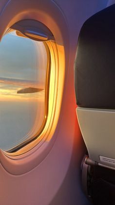 the view from inside an airplane window at sunset