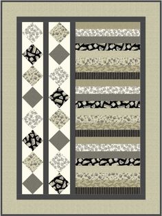 a quilted wall hanging with black and white designs on it's borders