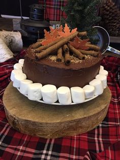 a chocolate cake with marshmallows and cinnamon sticks