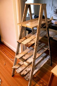 a wooden ladder shelf sitting on top of a hard wood floor