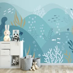 an underwater scene wallpaper mural in a child's room with toys on the floor