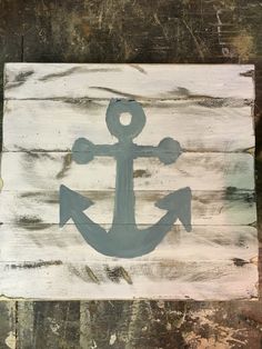 an anchor painted on wood is shown