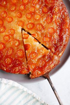 a close up of a pie on a plate with a slice taken out of it