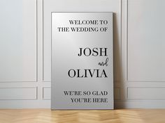 a welcome sign for the wedding of joshua and oliva in front of a white wall