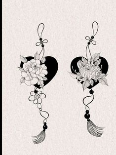 two hearts with flowers and tassels hanging from them