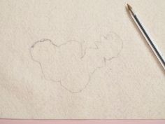 a pencil is laying on top of a piece of paper with a drawing of a bear