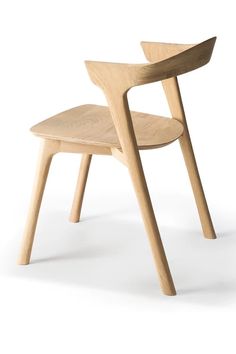 a wooden chair sitting on top of a white floor