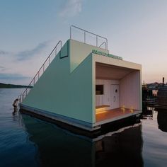 a boathouse floating on top of a body of water