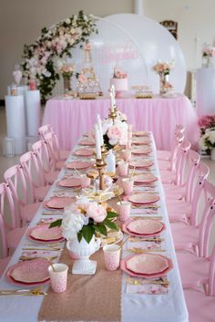 a long table with pink and gold decorations