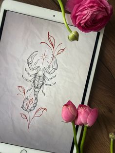 an ipad with a drawing of a scorpion on the screen next to pink flowers and tulips