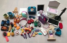 there are many different toys on the table together, including an electronic device and other items