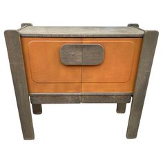 an orange and grey wooden cabinet with metal handles