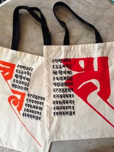 two bags with different designs on them sitting on a table