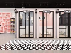 the floor is covered in black and white tiles, with three doors on each side