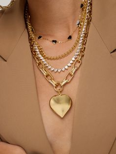 Add a charming touch to your outfit with our Encouraged Mini Bow Necklace! This dainty accessory features a mini bow and pearl, perfect for layering or wearing on its own. Cute and versatile, it's a must-have addition to any jewelry collection. Large Chain Heart Necklace 18k Gold Plated Over Brass 41 + 5 cm long Cubic Zirconium Detailing on Chain Extendable Lobster Clasp Trendy Heart Shaped Necklace With Gold Chain, Trendy Heart Charm Chain Necklace For Party, Chic Heart Charm Necklace For Party, Gold Heart Necklace With Heart Charm For Party, Chic Party Necklace With Heart Charm, Gold Heart Charm Necklace For Party, Gold Heart Pendant Chain Necklace For Party, Trendy Gold Heart Pendant Chain Necklace, Glamorous Gold Chain Necklace As Gift