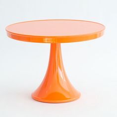 an orange glass table on a white background