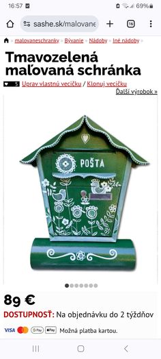 a green post box with flowers on it and the words posta written in russian