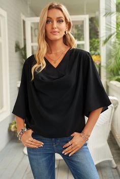 This three-quarter sleeve blouse offers a casual, minimalist style. It has a loose dolman sleeve and is designed with a cowl neck to add softness to the shape while keeping things modern and fresh. Wear it with skinny jeans or a pair of black pants for a variety. Sizing category: Regular Picture style: Outdoors Pattern type: Solid Style: Casual, minimalist Features: Straight hem Neckline: Cowl neck Length: Regular Sleeve length: Three-quarter sleeves Sleeve type: Dolman sleeves Material: 95% pol Jeans And Tops, Three Quarter Sleeve Blouses, Draped Blouse, Loose Blouse, Casual Blouse, Casual Top, Plus Size Casual, Blue Blouse, Three Quarter Sleeves