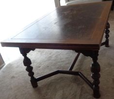 a wooden table sitting on top of a carpeted floor