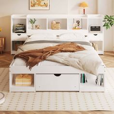 a white bed with drawers underneath it in a bedroom