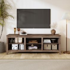 an entertainment center with a large flat screen tv mounted on the wall