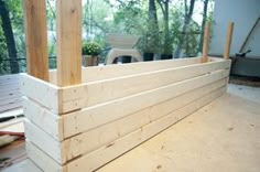 an unfinished porch with wood planks on the floor