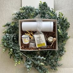 a box with some items in it sitting on top of a table next to a plant